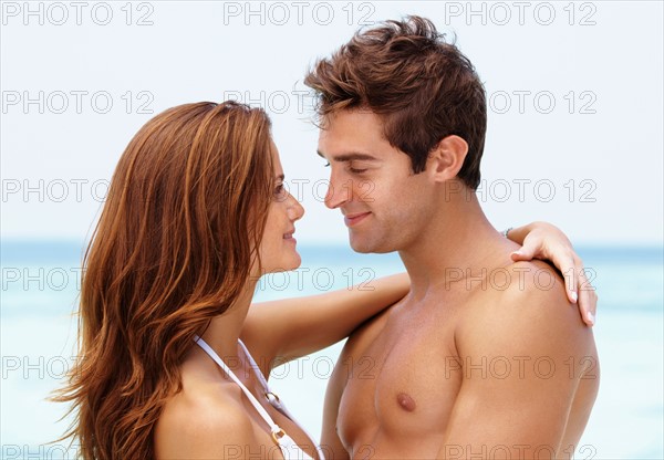 Young attractive couple enjoying summer holiday on beach