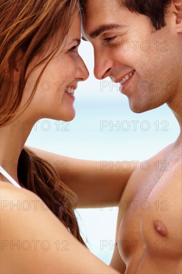 Young attractive couple enjoying summer holiday on beach