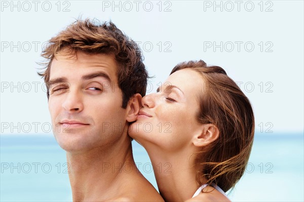 Young attractive couple enjoying summer holiday on beach