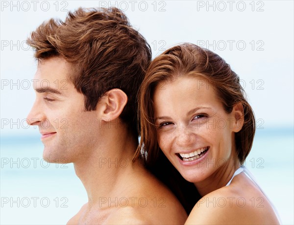 Young attractive couple enjoying summer holiday on beach