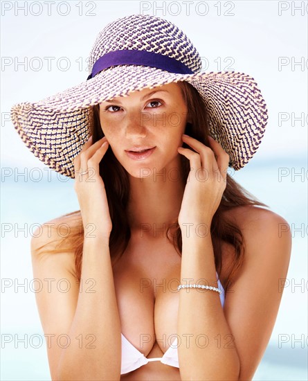 Beach portrait of young woman wearing white bikini