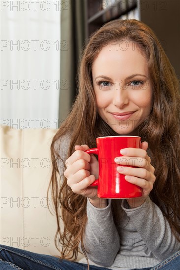 Portrait of smiling woman holding mug