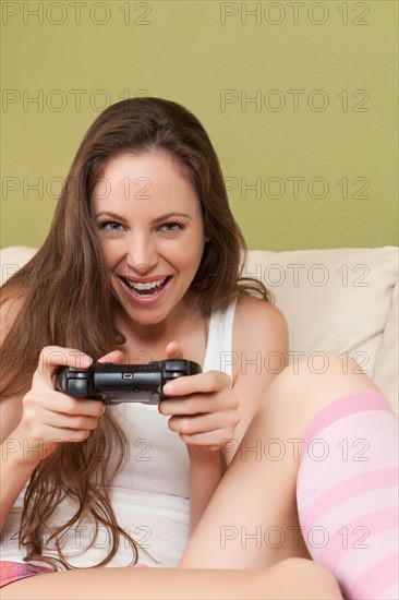 Smiling woman playing video game