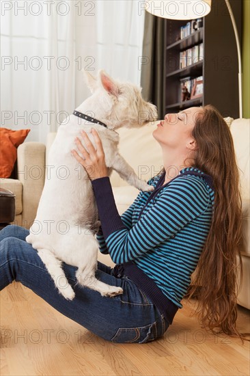 Woman kissing her dog