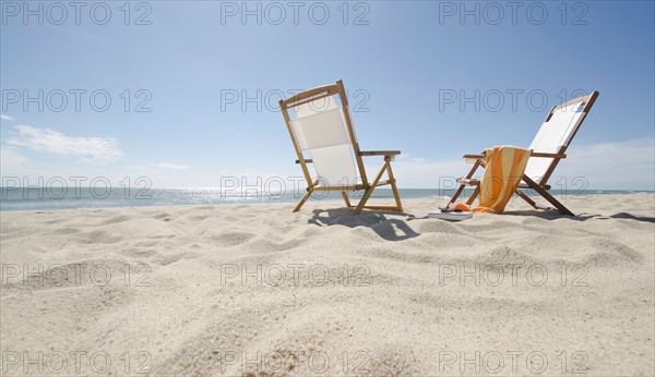 Sun chairs on sandy beach