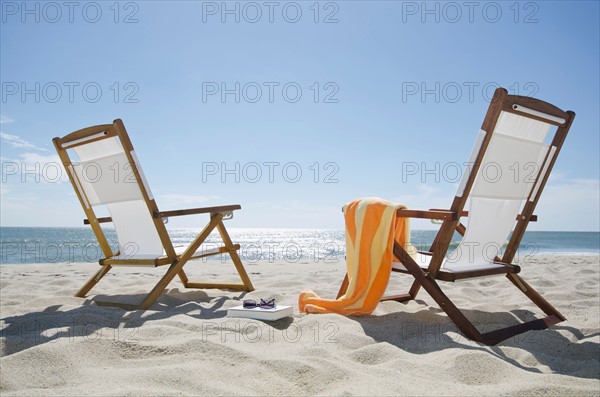 Sun chairs on sandy beach