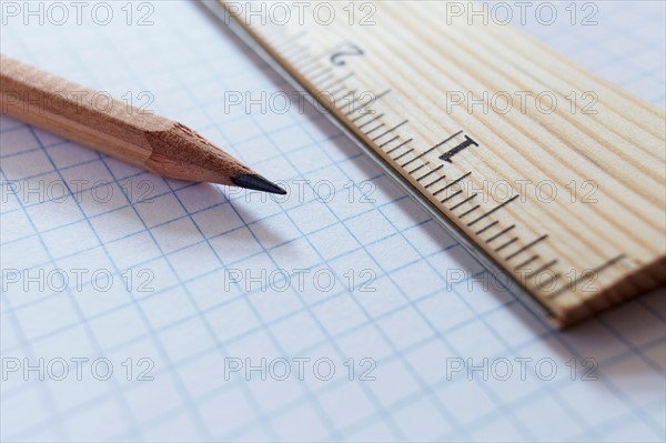 Ruler and pencil on graph paper, studio shot