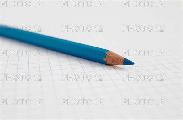 Blue pencil on graph paper, studio shot