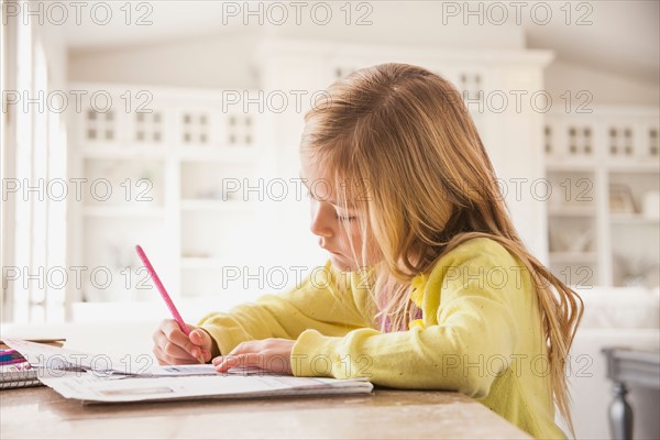 Girl (6-7) doing homework