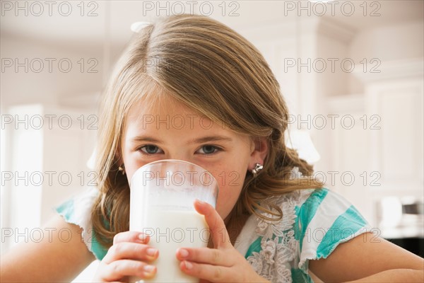 Girl (6-7) drinking milk