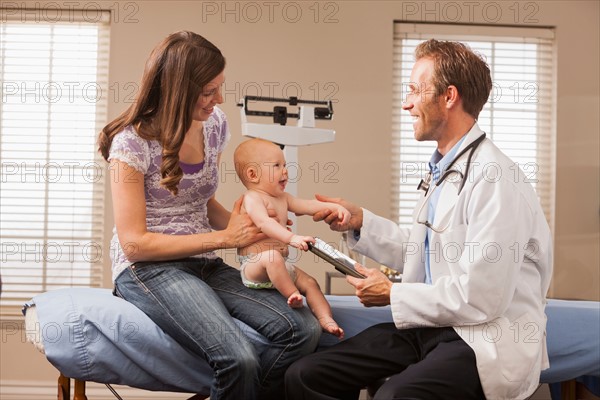 Mother with son (2-5 months) in doctor's office