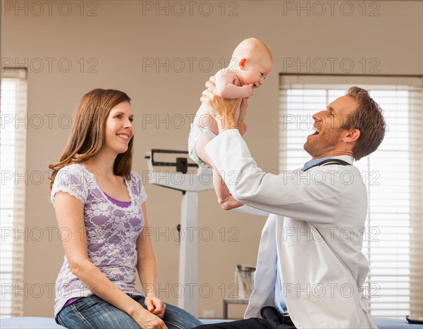 Mother with son (2-5 months) in doctor's office