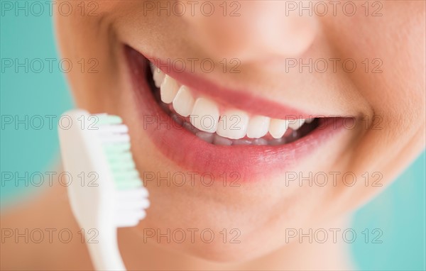 Close-up of woman brushing teeth.