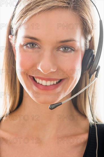 Studio portrait of young woman wearing headset.