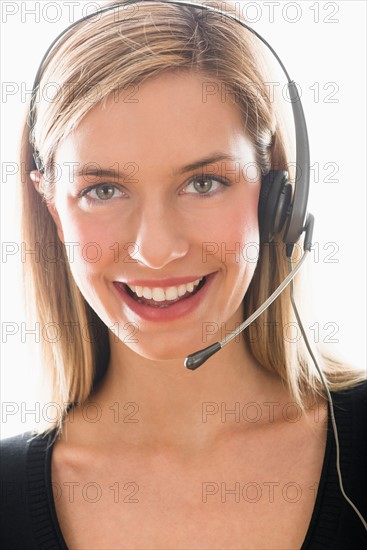 Studio portrait of young woman wearing headset.