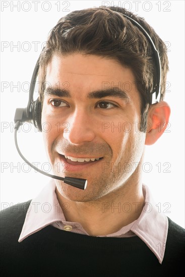 Studio portrait of man wearing headset.