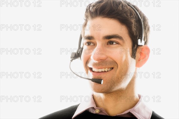 Studio portrait of man wearing headset.