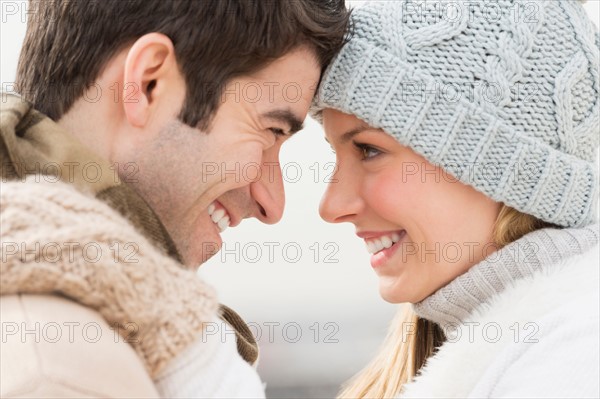 Profile of couple in winter clothing.