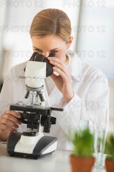 Scientist doing research on microscopes.