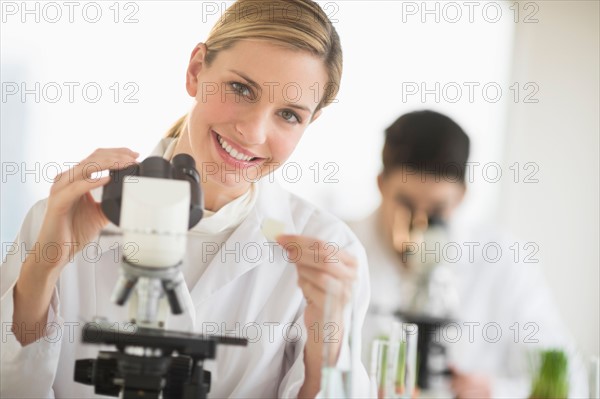 Scientists doing research on microscopes.