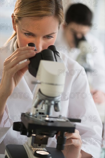 Scientist doing research on microscopes.