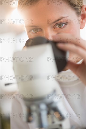 Scientist doing research on microscopes.