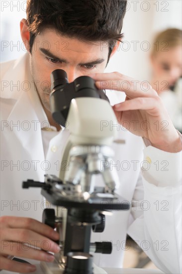 Scientist doing research on microscopes.