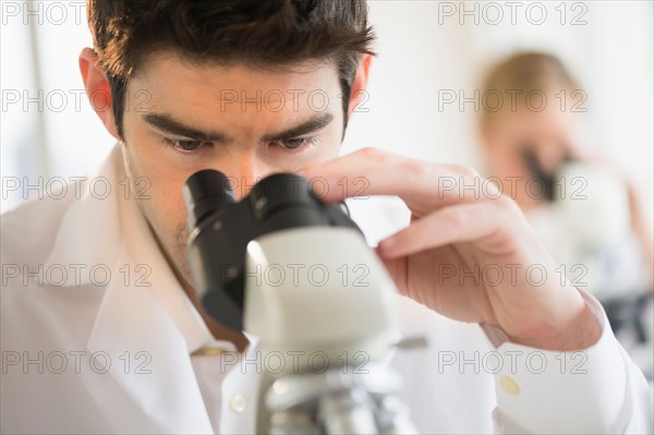 Scientist doing research on microscopes.