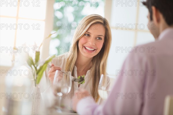 Couple eating dinner in restaurant.