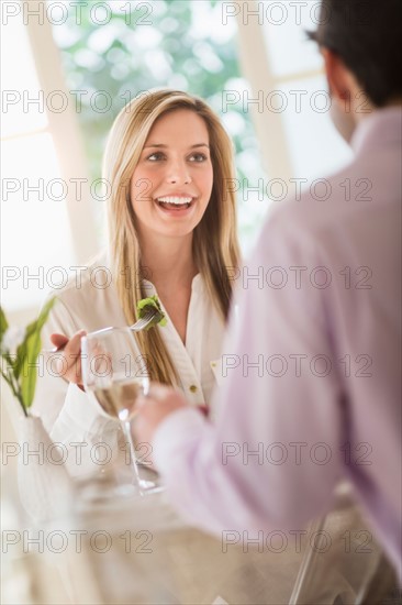 Couple eating dinner in restaurant.