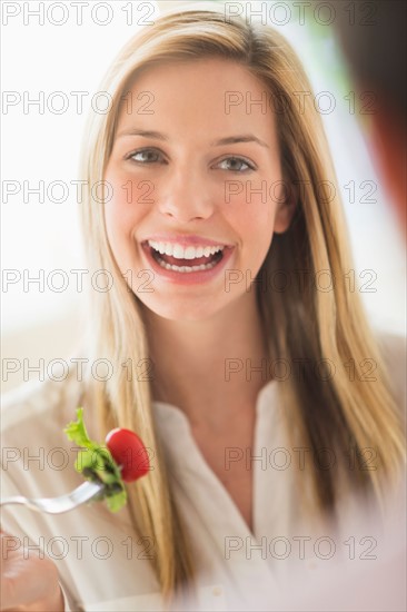 Woman eating and laughing.