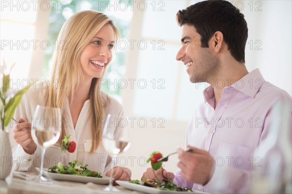 Couple eating dinner in restaurant.