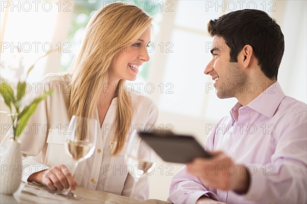 Couple in restaurant, man paying.