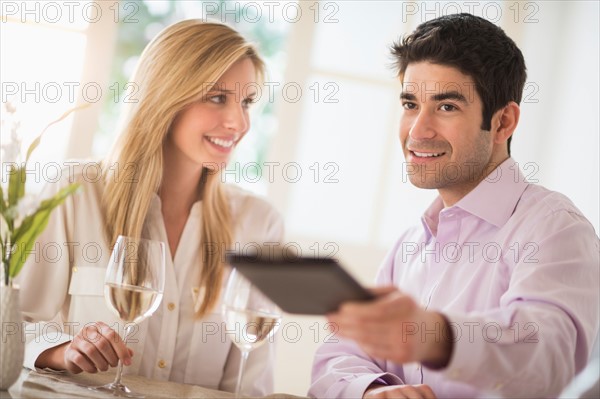 Couple in restaurant, man paying.