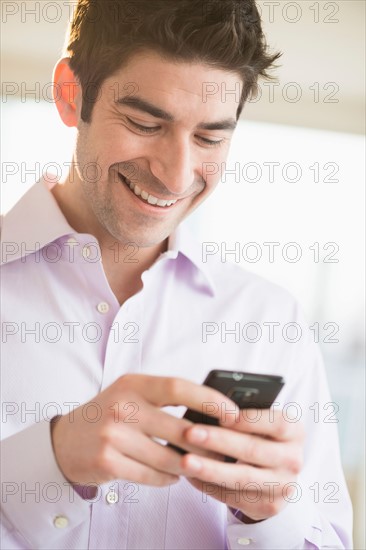 Man texting on smartphone.