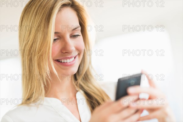Woman texting on smartphone.