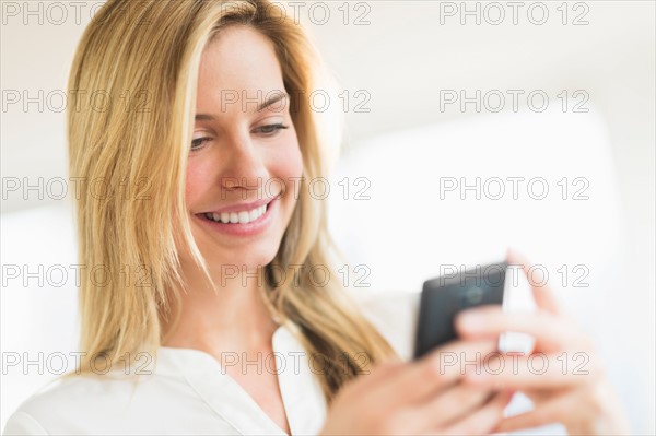 Woman texting on smartphone.