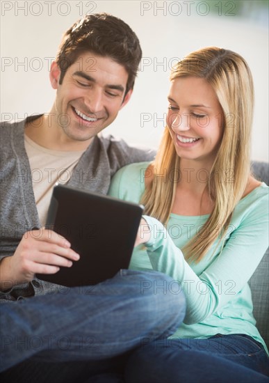 Couple using tablet pc.