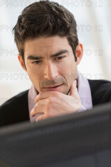 Business man looking at computer.