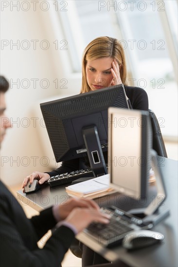 Business man and woman working in office.