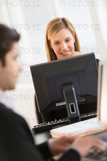 Business man and woman working in office.