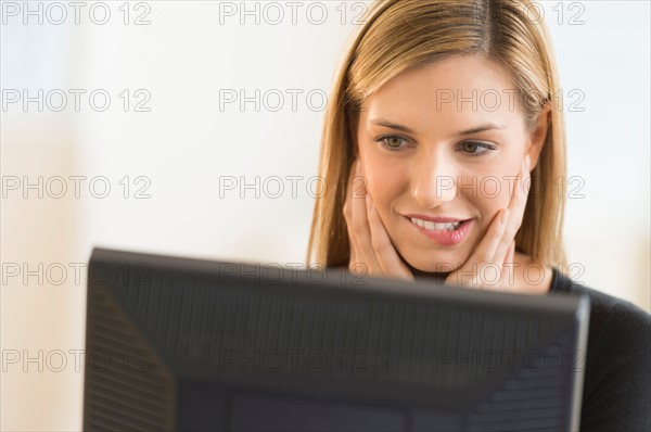 Business woman looking at computer.