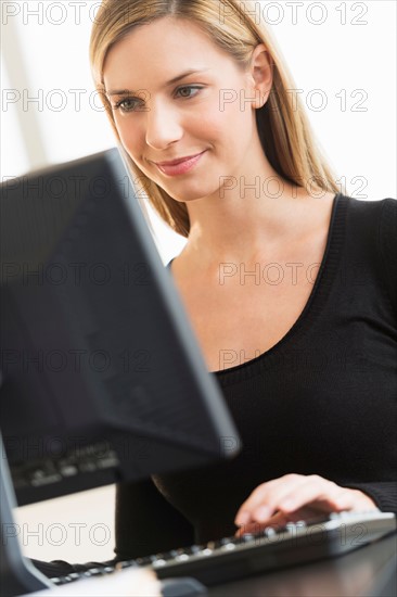 Business woman looking at computer.