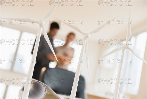 Scale models of wind turbines on office desk.