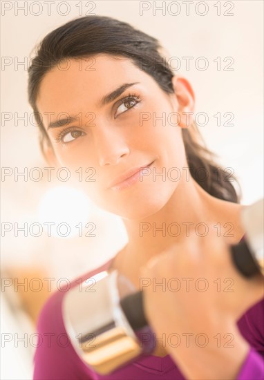 Woman lifting dumbbell.