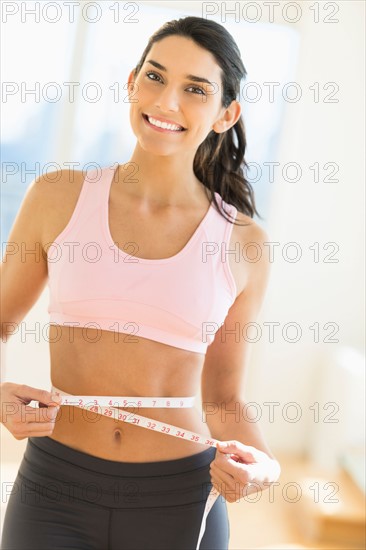 Woman measuring waist.