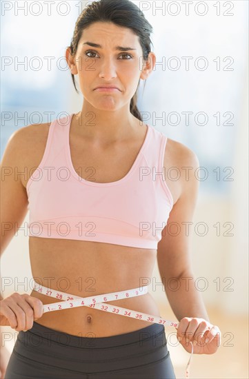 Woman measuring waist.