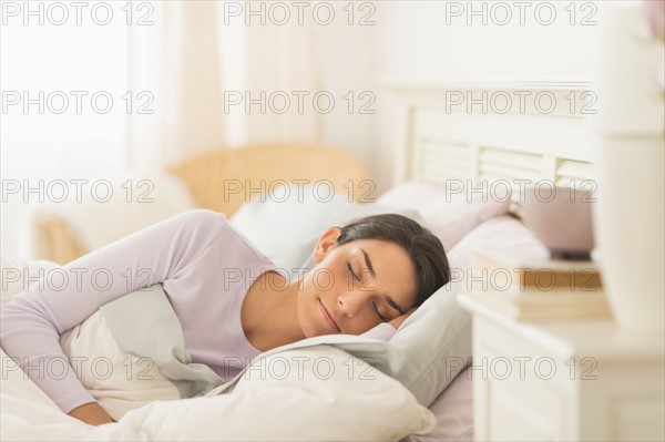 Woman sleeping in bed.