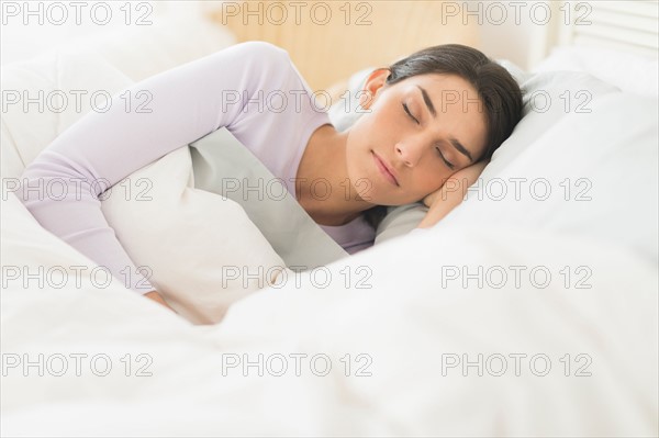 Woman sleeping in bed.