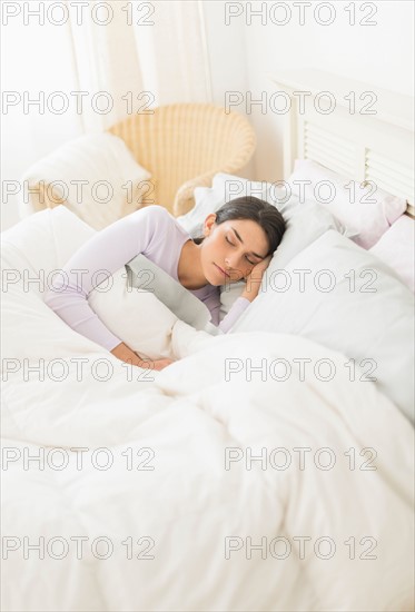 Woman sleeping in bed.